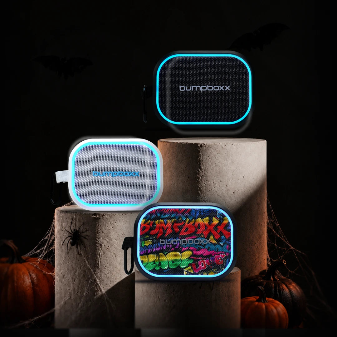 Fistbump in black, white and graffiti on stone podiums with pumpkins and spider webs